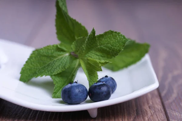 Sprigs Mint Blueberries White Plate Wooden Background — 스톡 사진