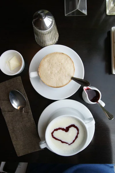 Coffee with milk and milk porridge on table. Breakfast concept
