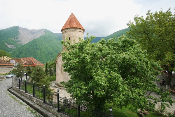 stone old castle in the village on mountains background