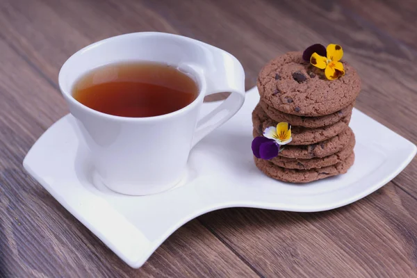 Cup Tea Stack Chocolate Cookies Flowers — Stock Photo, Image