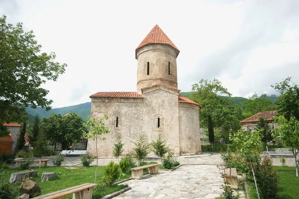 stone old castle in the village on mountains background