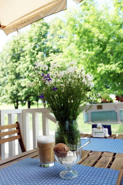 Coffee and ice cream on a table in a coffee shop. Moscow, June, 2020.