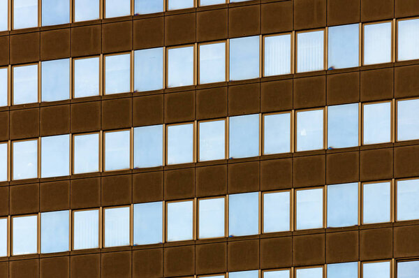 Closeup of skycraper business center. Glass business center with blue sky. windows of modern office centre.