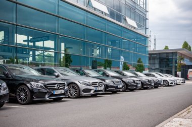 Mercedes Benz cars parked in row clipart