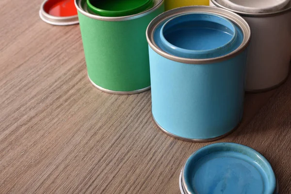 Assortment Open Paint Cans Covers Wooden Table Elevated View Horizontal — Stock Photo, Image