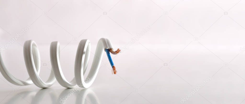 Electricity concept with coiled cable on reflected table and white background. Front view. Horizontal composition.