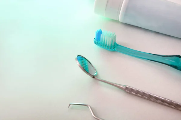 Dentist tools on table with green light elevated — Stock Photo, Image