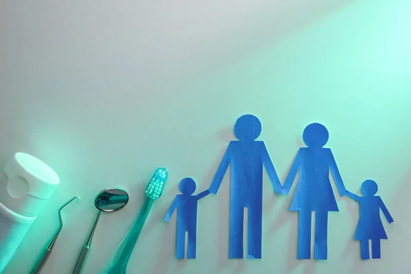 Family dental health concept with tools on table green light