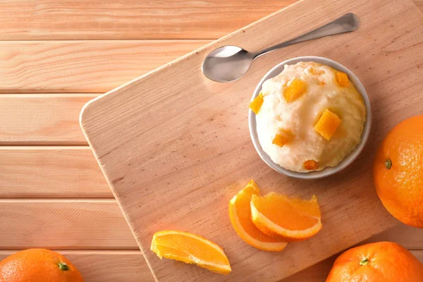 Orange ice cream cup decorated with orange segments top