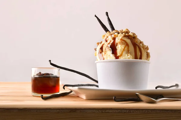 Vanilla and caramel ice cream cup decorated with pods