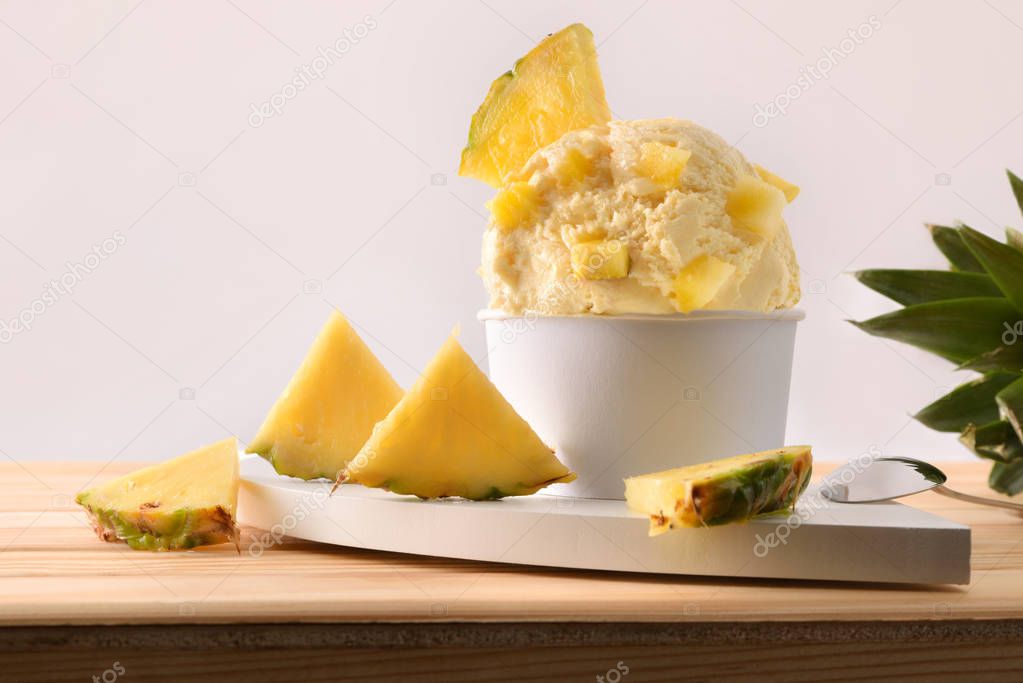 Pineapple ice cream cup decorated with pineapple chunks
