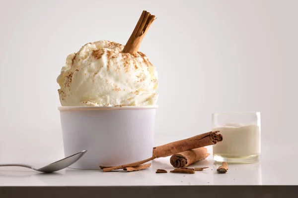 Composition of cinnamon ice cream ball in paper cup — Stock Photo, Image