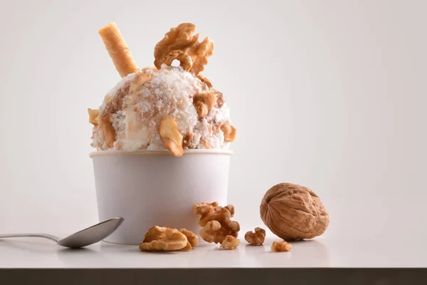 Composition of walnuts ice cream ball in paper cup — Stock Photo, Image