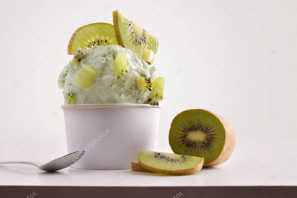 Composition of kiwi ice cream ball in paper cup