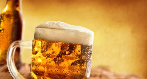 Pitcher full of beer with foam with barley ears detail Royalty Free Stock Images