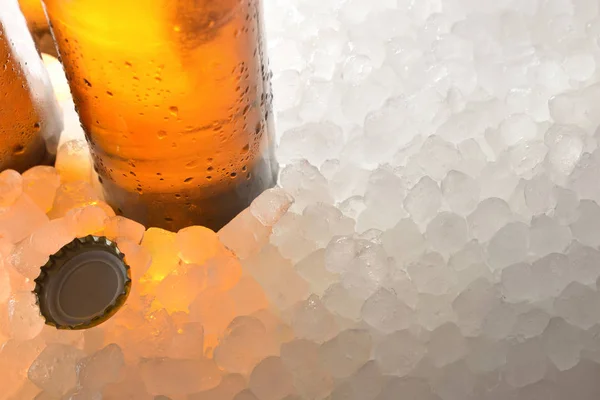 Beer glass bottle on crushed ice and cap — Stock Photo, Image