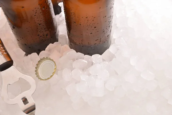 Beer bottles with bottle and cap on crushed ice — Stock Photo, Image