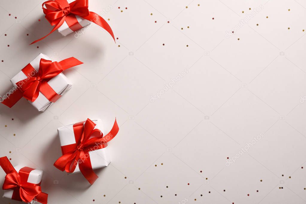 Background with four white Christmas gift boxes on the left