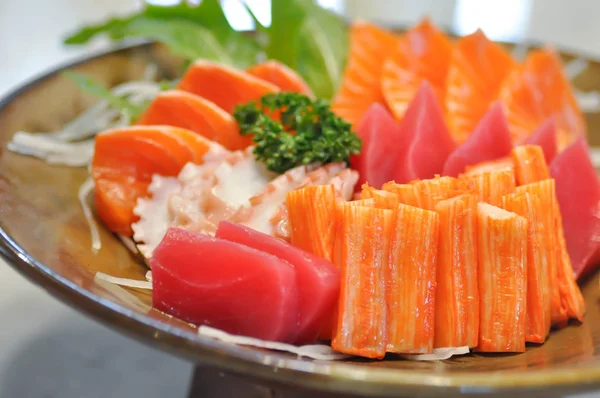raw salmon , raw tuna and raw squid or sashimi