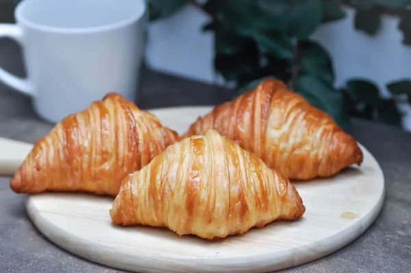 Croissant or French croissants in the wooden tray — Stock Photo, Image