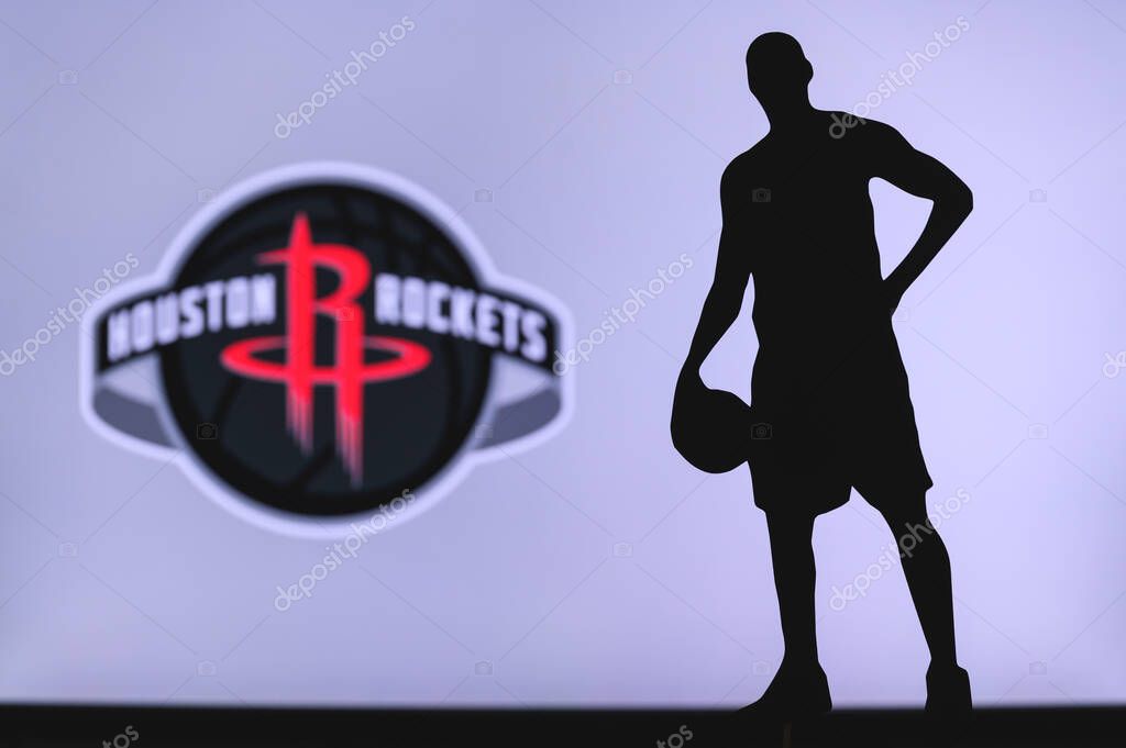 NEW YORK, USA, JUN 18, 2020: Houston Rockets logo of professional basketball club in american league. Silhouette of basket player in foreground. Sport concept photo, edit space.