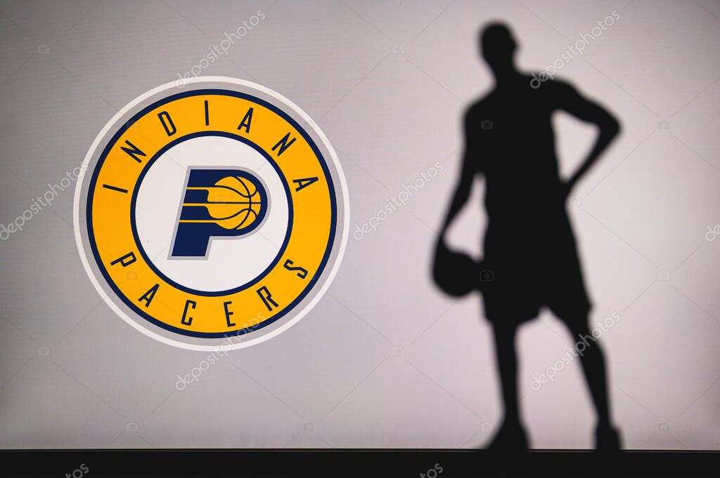 NEW YORK, USA, JUN 18, 2020: Indiana Pacers logo of professional basketball club in american league. Silhouette of basket player in foreground. Sport concept photo, edit space.