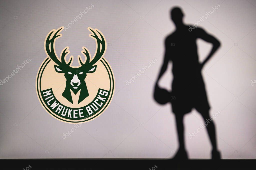 NEW YORK, USA, JUN 18, 2020: logo of professional basketball club in american league. Silhouette of basket player in foreground. Sport concept photo, edit space.