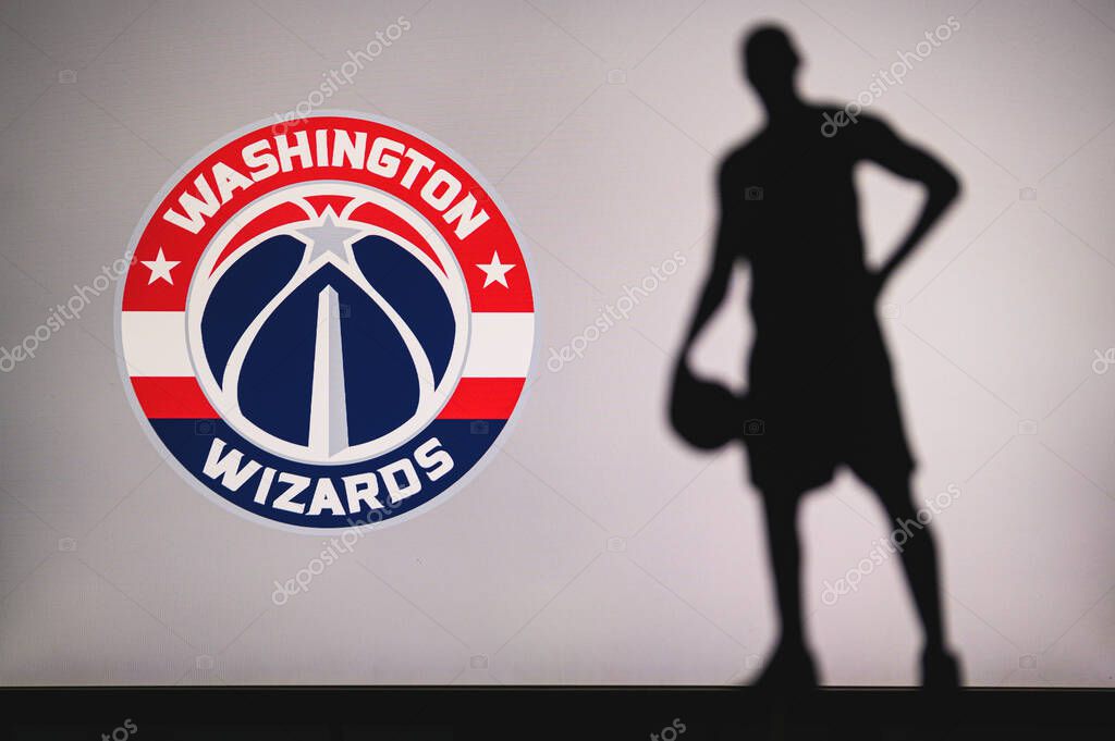 NEW YORK, USA, JUN 18, 2020: Washington Wizards logo of professional basketball club in american league. Silhouette of basket player in foreground. Sport concept photo, edit space.