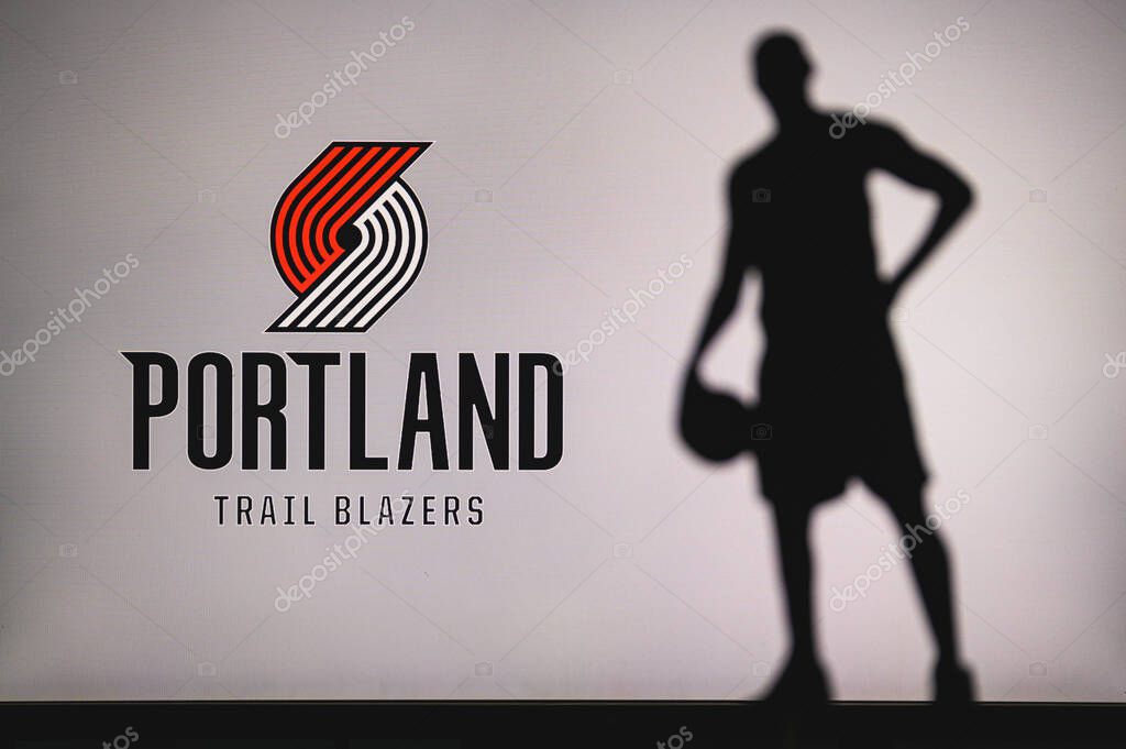 NEW YORK, USA, JUN 18, 2020: Portland Trail Blazers logo of professional basketball club in american league. Silhouette of basket player in foreground. Sport concept photo, edit space.