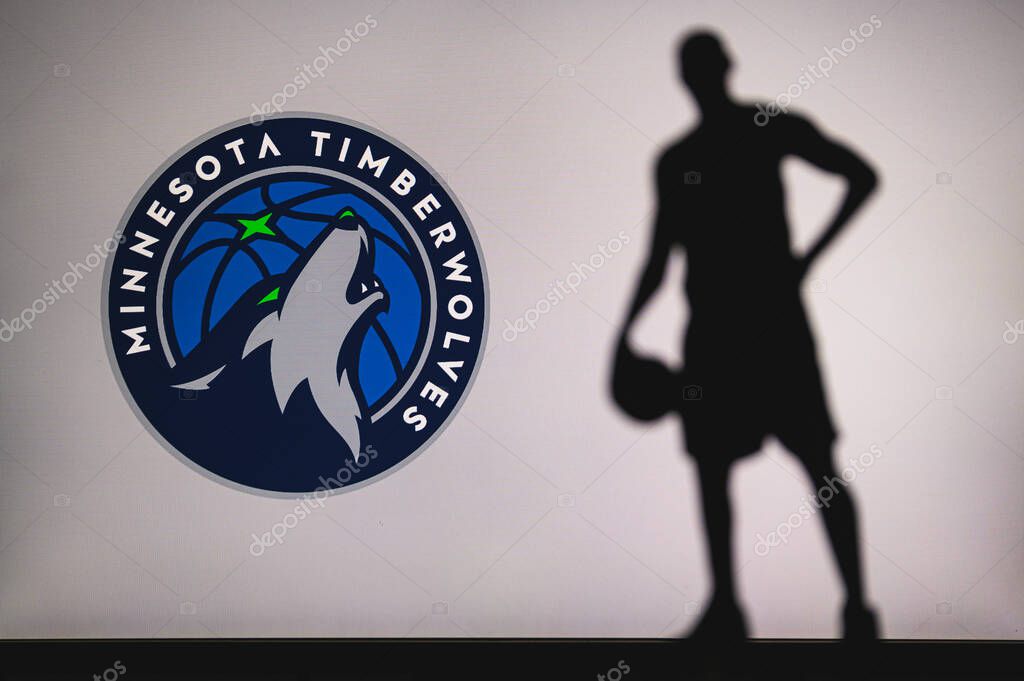 NEW YORK, USA, JUN 18, 2020: Minnesota Timberwolves logo of professional basketball club in american league. Silhouette of basket player in foreground. Sport concept photo, edit space.