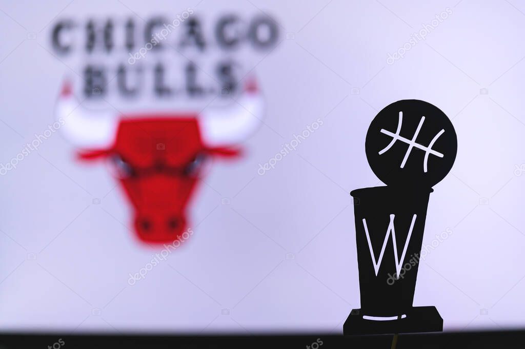 NEW YORK, USA, JUN 18, 2020: Chicago Bulls Basketball club on the white screen. Silhouette of NBA trophy in foreground.