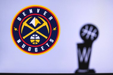 NEW YORK, ABD, 18 Haziran 2020: Denver Nuggets Basketbol Kulübü beyaz ekranda. Ön planda NBA kupasının silueti.