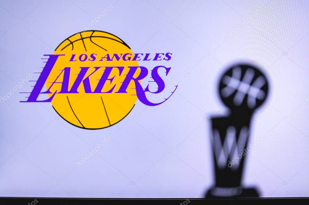 NEW YORK, USA, JUN 18, 2020: Los Angeles Lakers Basketball club on the white screen. Silhouette of NBA trophy in foreground.