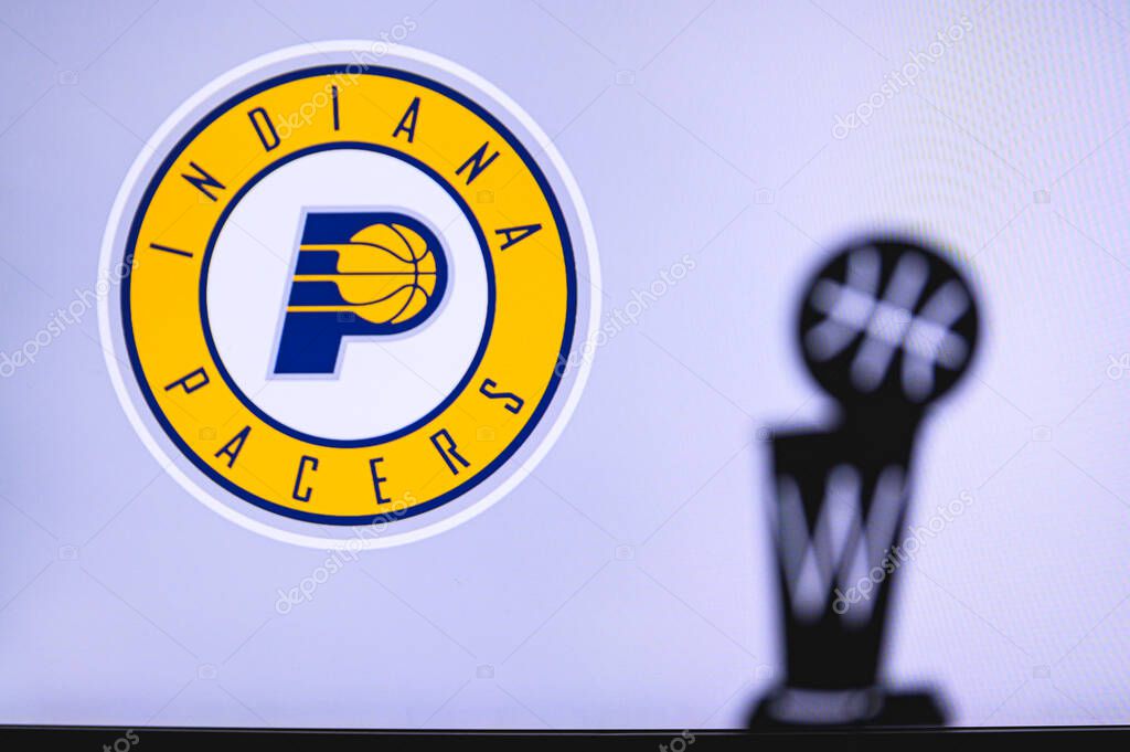 NEW YORK, USA, JUN 18, 2020: Indiana Pacers Basketball club on the white screen. Silhouette of NBA trophy in foreground.