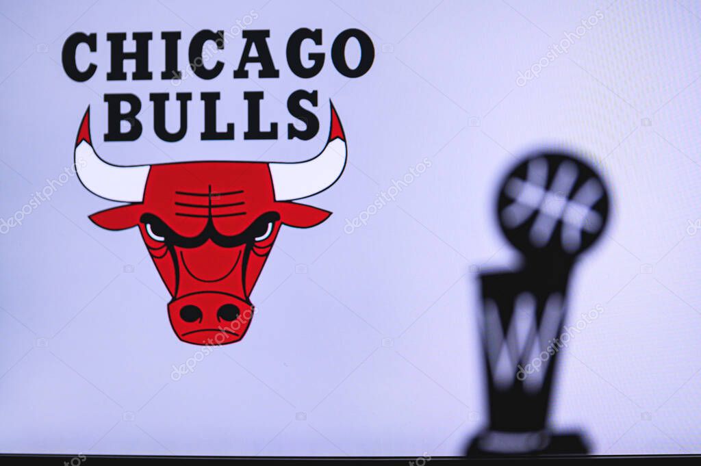 NEW YORK, USA, JUN 18, 2020: Chicago Bulls Basketball club on the white screen. Silhouette of NBA trophy in foreground.