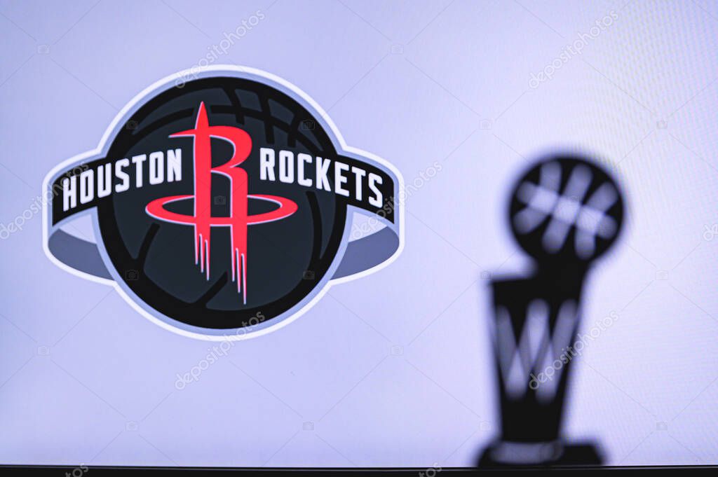 NEW YORK, USA, JUN 18, 2020: Houston Rockets Basketball club on the white screen. Silhouette of NBA trophy in foreground.