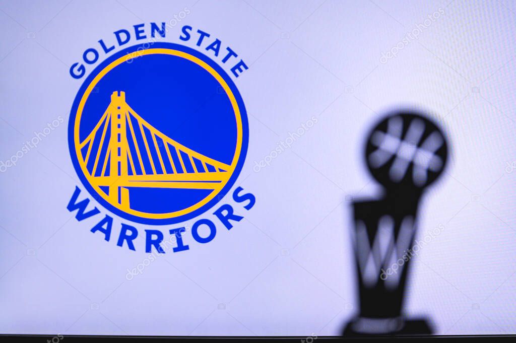 NEW YORK, USA, JUN 18, 2020: Golden State Warriors Basketball club on the white screen. Silhouette of NBA trophy in foreground.
