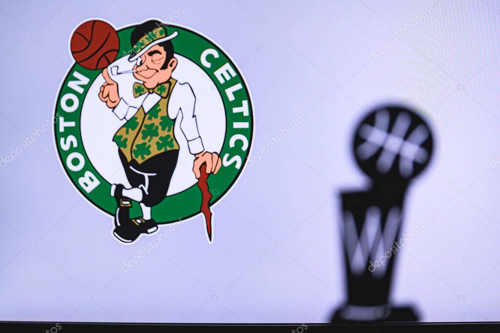 NEW YORK, USA, JUN 18, 2020: Boston Celtics Basketball club on the white screen. Silhouette of NBA trophy in foreground.