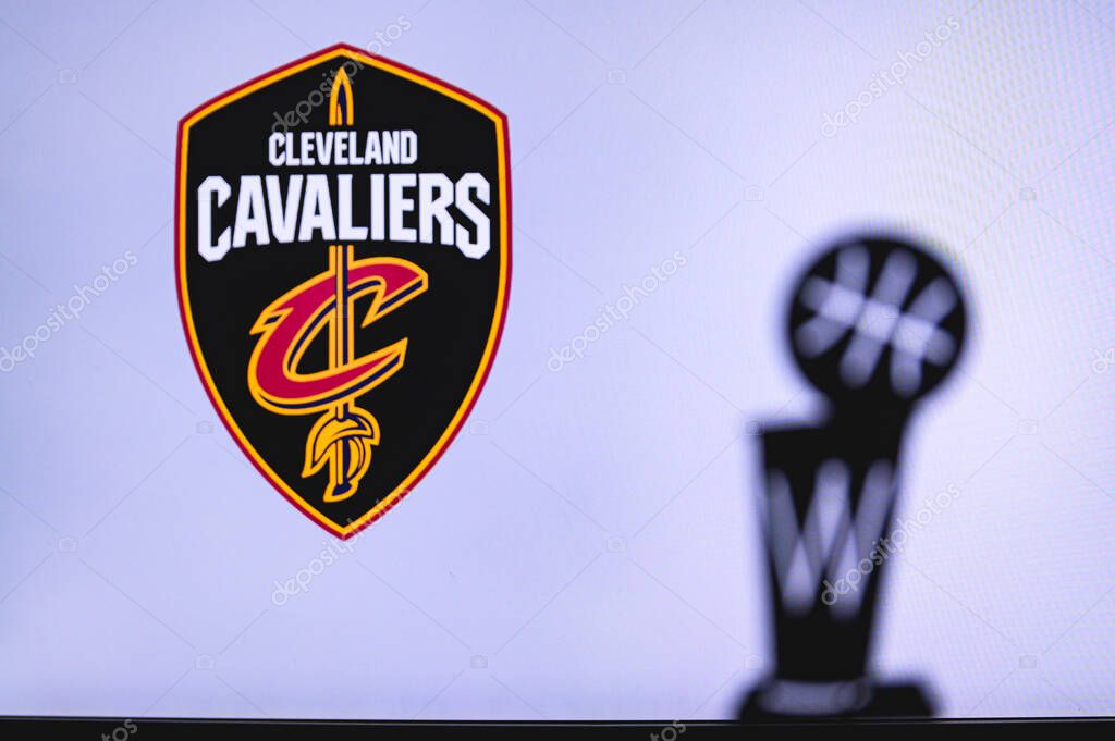 NEW YORK, USA, JUN 18, 2020: Cleveland Cavaliers Basketball club on the white screen. Silhouette of NBA trophy in foreground.