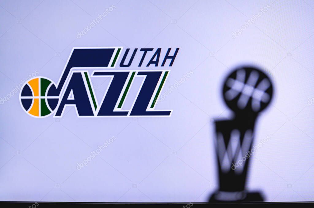 NEW YORK, USA, JUN 18, 2020: Utah Jazz Basketball club on the white screen. Silhouette of NBA trophy in foreground.
