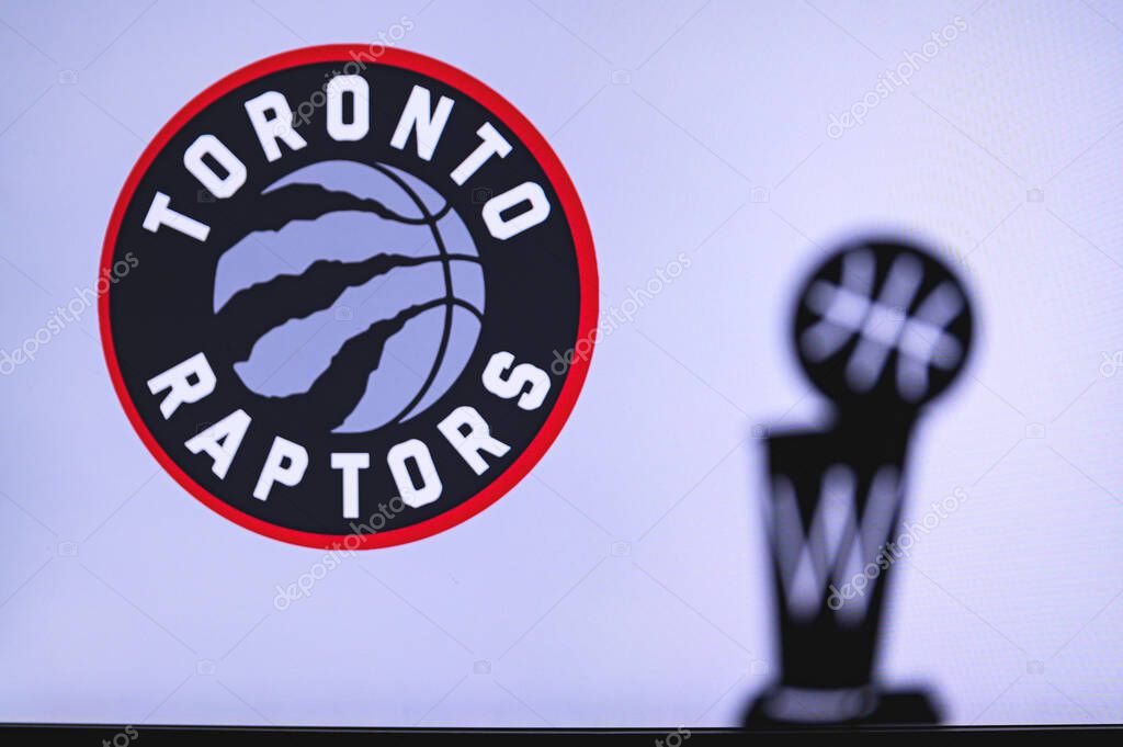NEW YORK, USA, JUN 18, 2020: Toronto Raptors Basketball club on the white screen. Silhouette of NBA trophy in foreground.