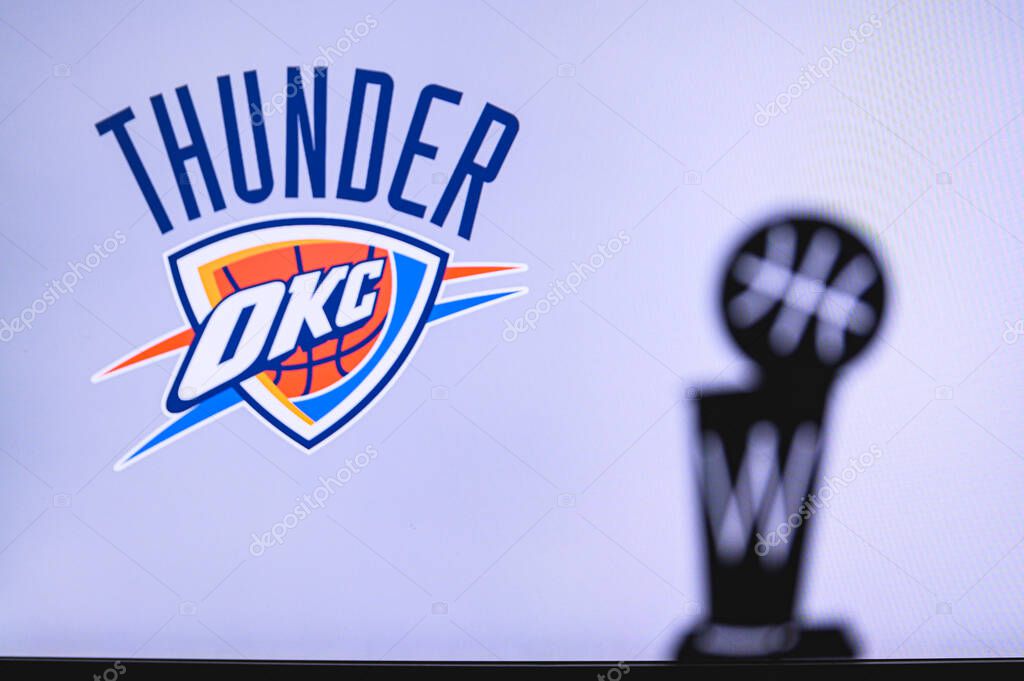 NEW YORK, USA, JUN 18, 2020: Oklahoma City Thunder Basketball club on the white screen. Silhouette of NBA trophy in foreground.