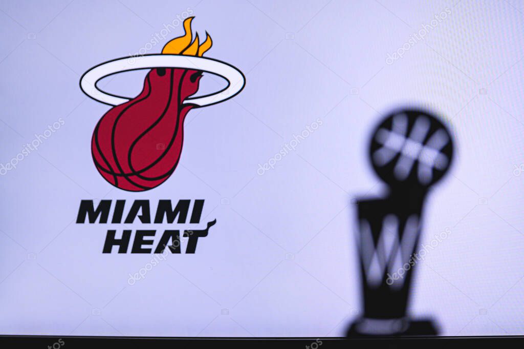 NEW YORK, USA, JUN 18, 2020: Miami Heat Basketball club on the white screen. Silhouette of NBA trophy in foreground.