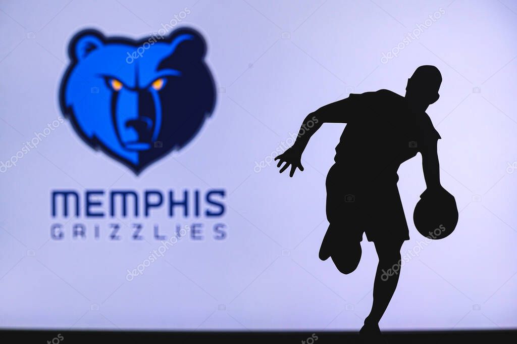 NEW YORK, USA, JUN 18, 2020: Memphis Grizzlies basketball club logo and silhouette of young basketball player. Sport wallpaper, white edit space in background.