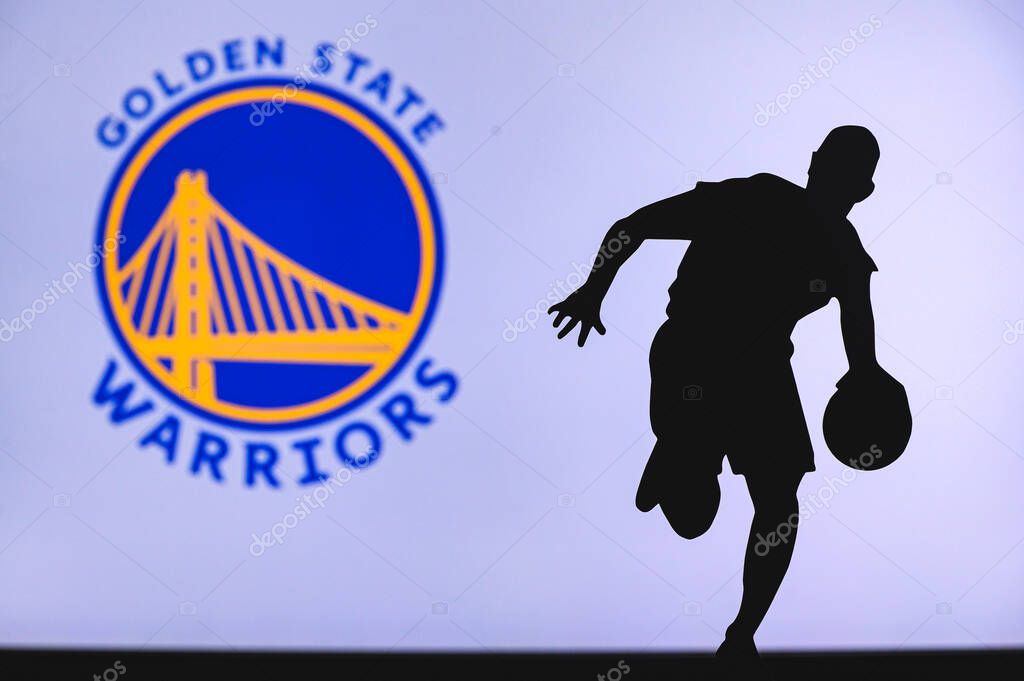 NEW YORK, USA, JUN 18, 2020: Golden State Warriors basketball club logo and silhouette of young basketball player. Sport wallpaper, white edit space in background.
