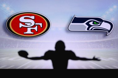 San Francisco 49ers, Seattle Seahawks 'a karşı. NFL oyunu. Amerikan Futbol Ligi maçı. Profesyonel oyuncunun silueti dokunuşu kutluyor. Arkaplanda ekran.