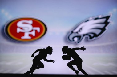 San Francisco 49ers, Philadelphia Eagles 'a karşı. NFL maç posteri. Sahada karşı karşıya gelen iki Amerikan futbolcu silueti. Arka planda kulüp logosu var. Rekabet konsepti fotoğrafı.
