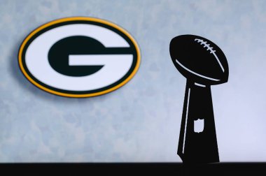 Green Bay Packers professional american football club, silhouette of NFL trophy, logo of the club in background. clipart