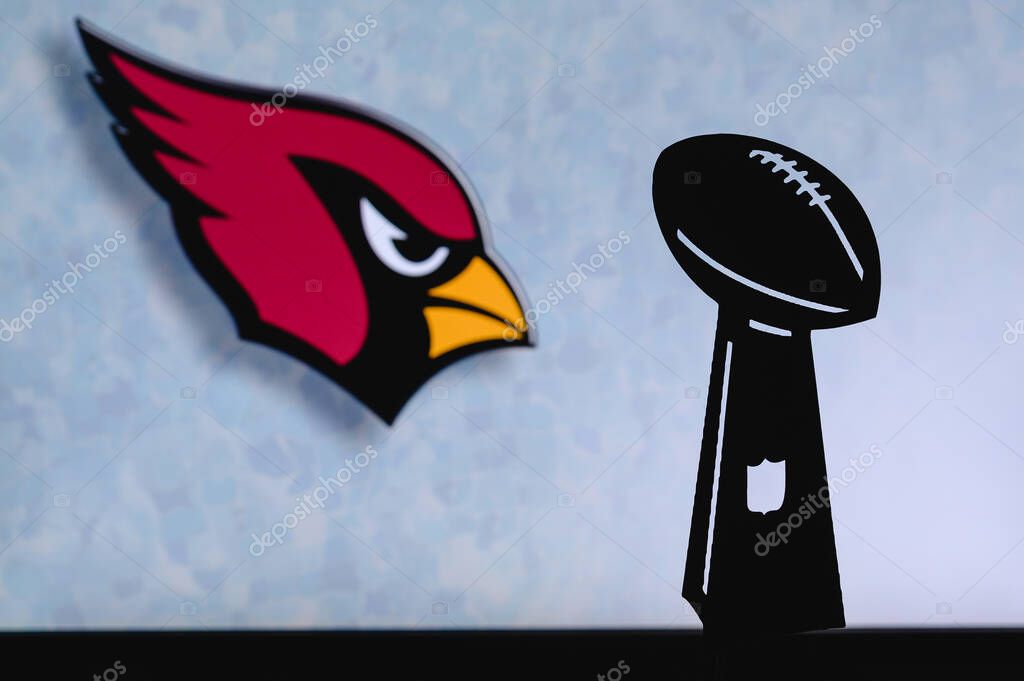 Arizona Cardinals professional american football club, silhouette of NFL trophy, logo of the club in background.