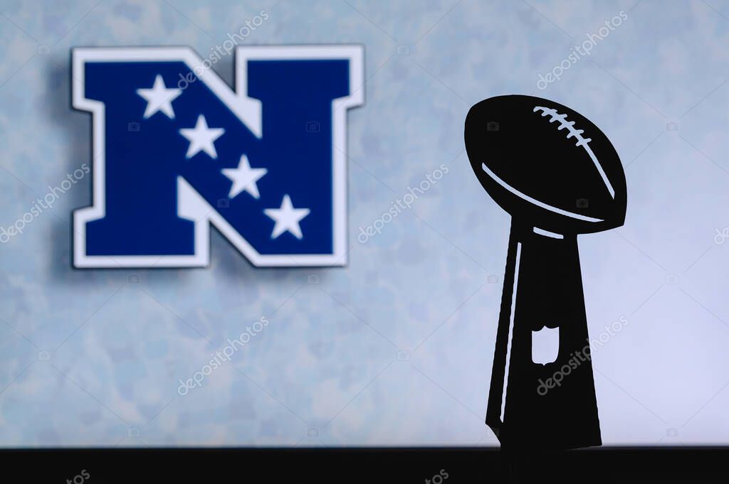 National Football Conference NFC, professional american football club, silhouette of NFL trophy, logo of the club in background.